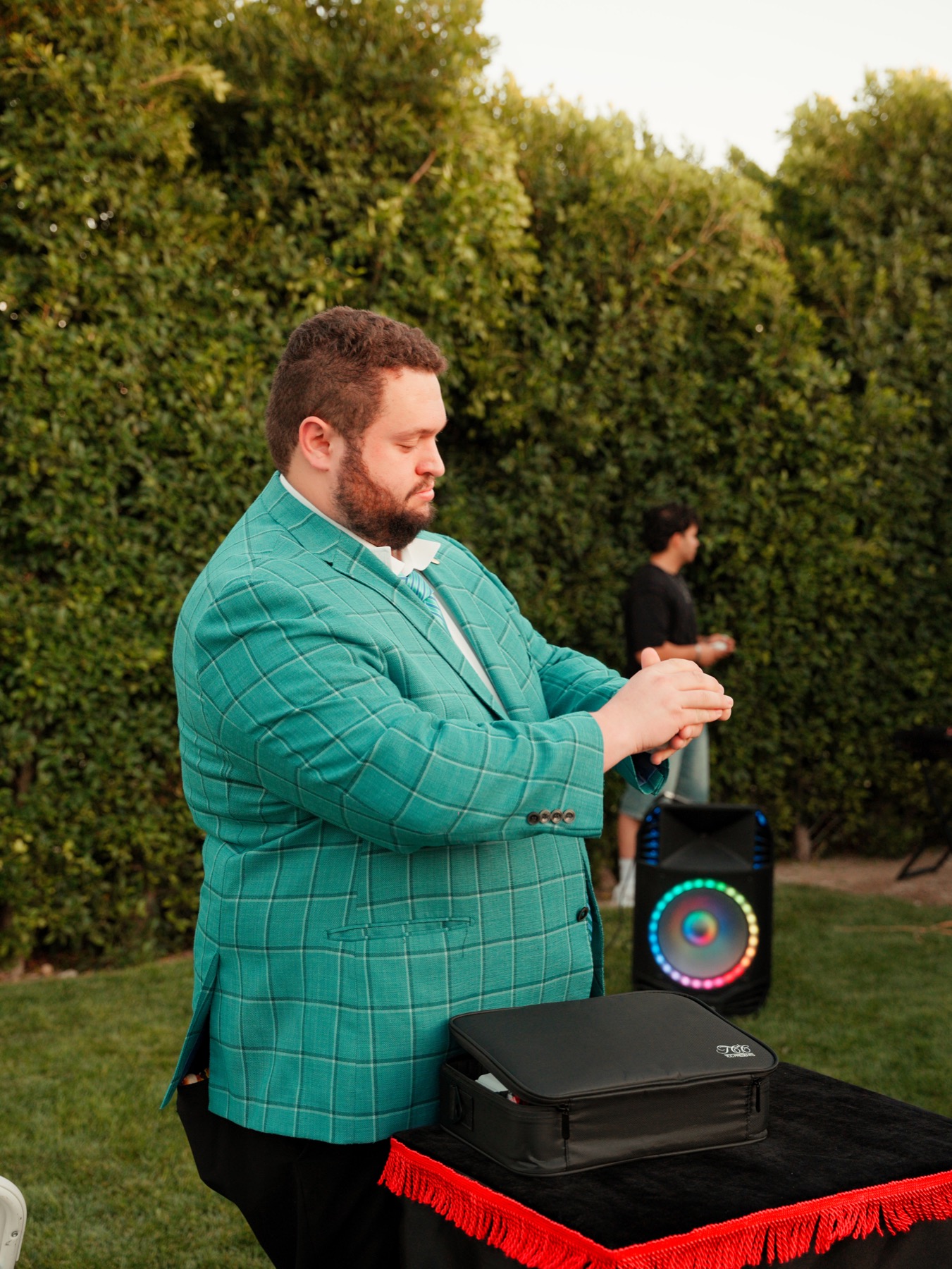 Bryce performing close-up magic at an outdoor party