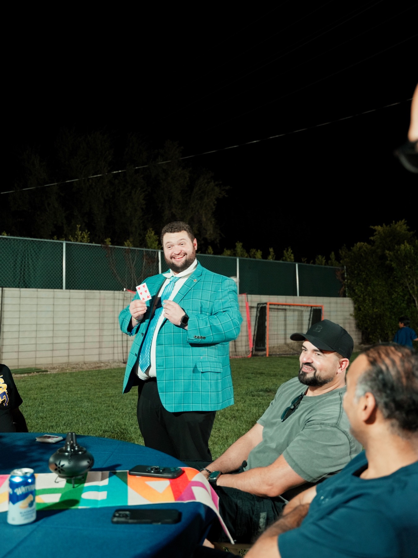Bryce sharing a card trick with guests at a celebration